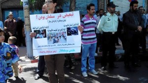 Ibrahim Nuri; carrying a placard criticizing Iran for discrimination among the Muslims which also reads:  Down with Armenia, China and Israel